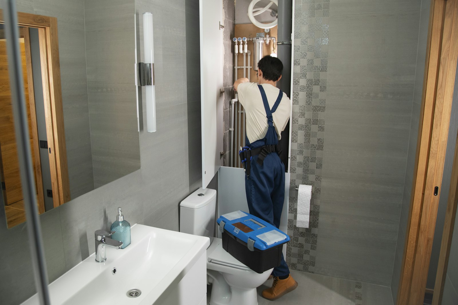 A plumber installing pipework in a bathroom